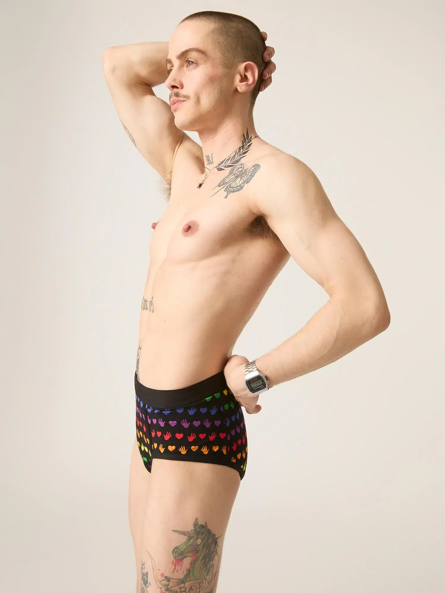 A trans man shows off a pair of rainbow-print Modibodi underwear. 